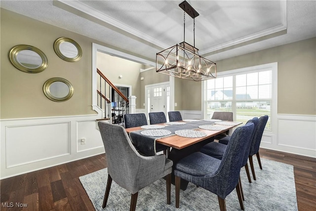 2716 Rocky Ridge Dr, Westlake, OH 44145 - dining area with a wainscoted wall, dark wood-type flooring, a raised ceiling, and ornamental molding