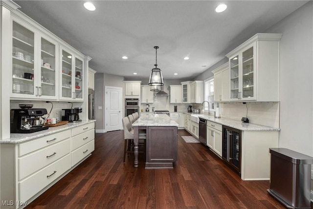 2716 Rocky Ridge Dr, Westlake, OH 44145 - kitchen featuring stainless steel appliances, dark wood-style flooring, wine cooler, a kitchen island, and recessed lighting
