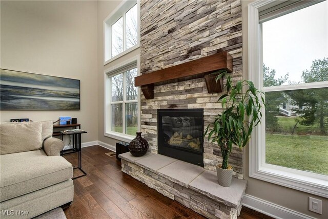 2716 Rocky Ridge Dr, Westlake, OH 44145 - living room with dark wood-type flooring, baseboards, visible vents, and a stone fireplace