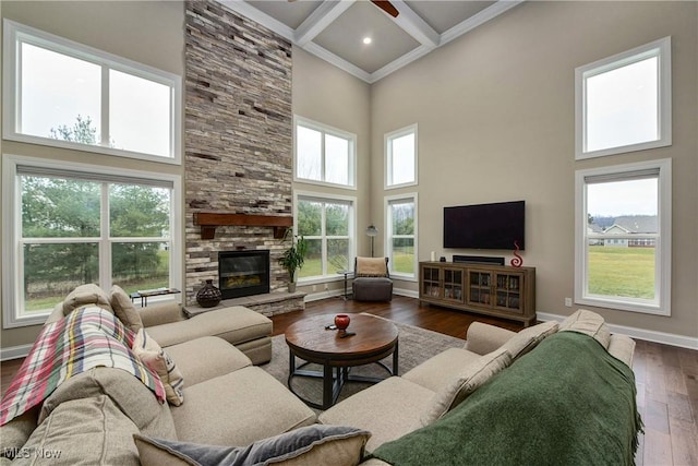 2716 Rocky Ridge Dr, Westlake, OH 44145 - living room featuring a towering ceiling, wood-type flooring, baseboards, and a stone fireplace