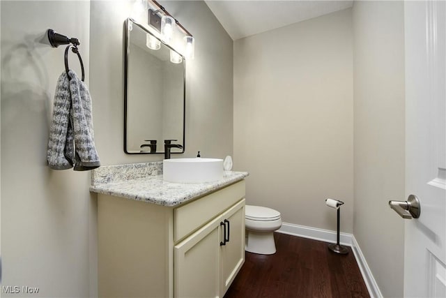 2716 Rocky Ridge Dr, Westlake, OH 44145 - half bathroom with toilet, baseboards, wood finished floors, and vanity