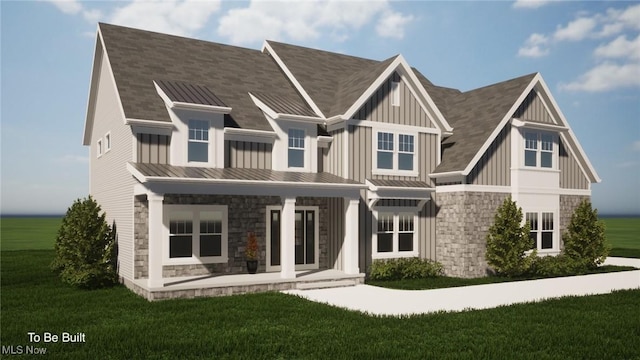 2716 Rocky Ridge Dr, Westlake, OH 44145 - view of front of house featuring a front lawn, a standing seam roof, stone siding, and board and batten siding