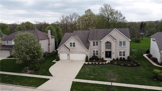 view of front of property featuring a front lawn and concrete driveway