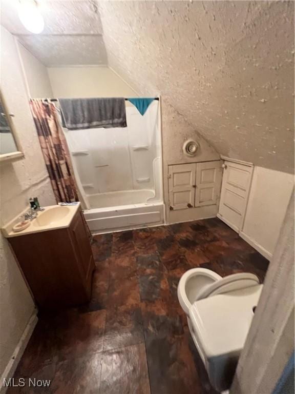 full bath with vanity, toilet, a textured ceiling, wood finished floors, and vaulted ceiling