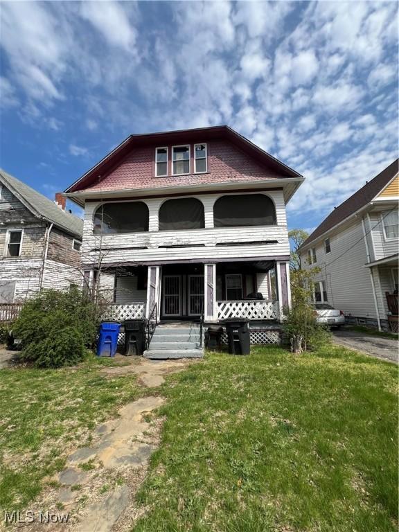view of front of home featuring covered porch and a front yard