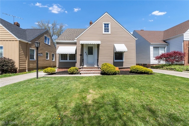 bungalow-style home featuring a chimney and a front yard