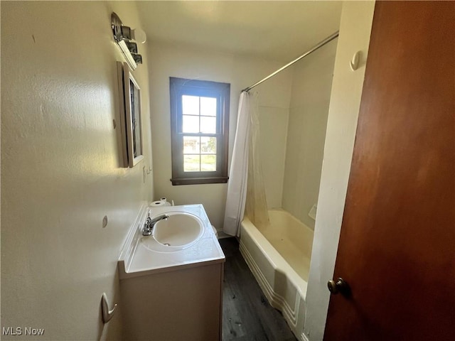 full bathroom featuring wood finished floors, shower / bath combo, and vanity