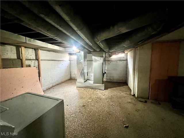 unfinished basement featuring heating unit