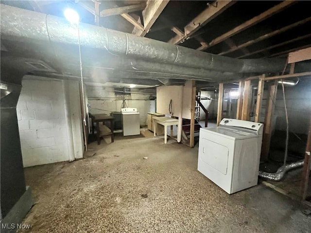 unfinished basement with washer / clothes dryer