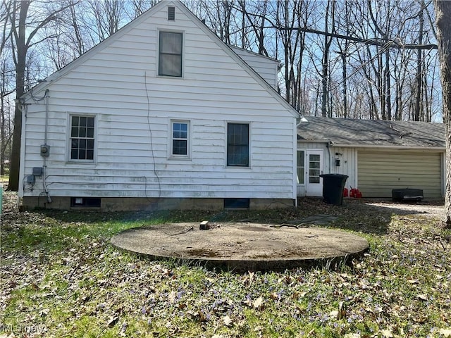 back of house with an attached garage