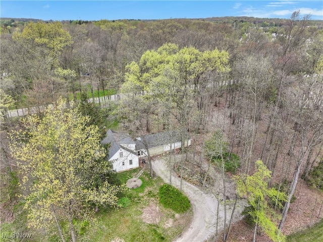 drone / aerial view with a wooded view