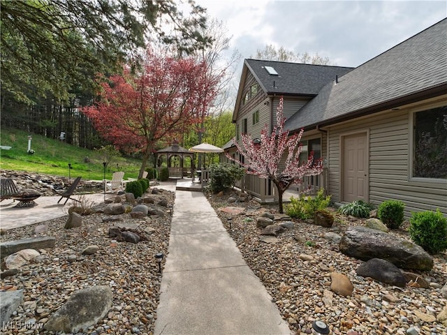 exterior space with a gazebo, a fire pit, and a patio area