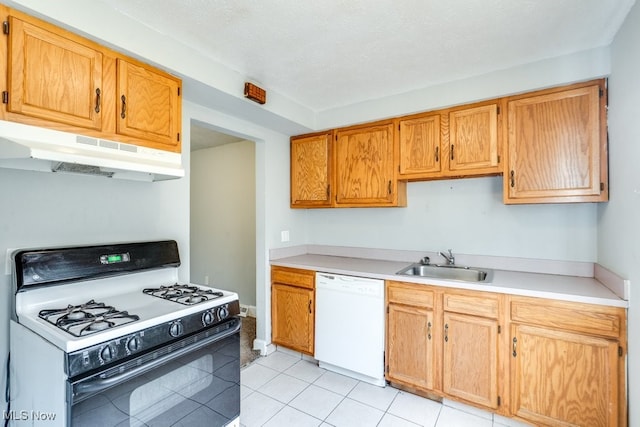 kitchen with range with gas stovetop, white dishwasher, light countertops, under cabinet range hood, and a sink