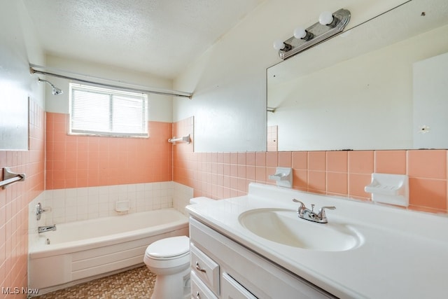 full bathroom featuring tile walls, wainscoting, shower / tub combination, vanity, and toilet