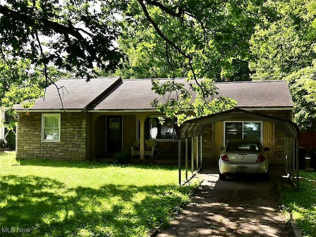 ranch-style house featuring a front lawn, covered porch, stone siding, roof with shingles, and driveway