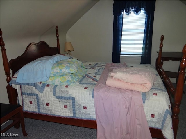 carpeted bedroom with vaulted ceiling