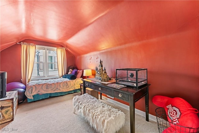 carpeted bedroom with baseboards and vaulted ceiling