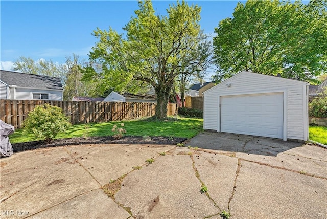 detached garage with fence and driveway