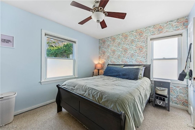 bedroom featuring baseboards, ceiling fan, carpet, and wallpapered walls