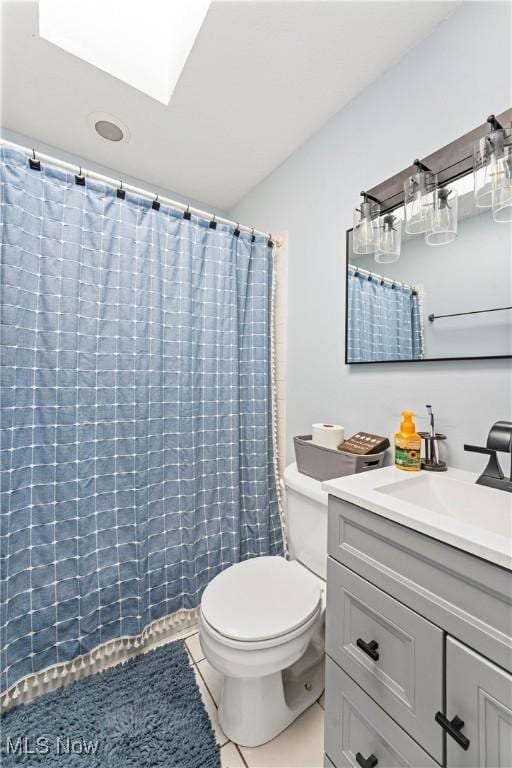 full bathroom featuring vanity, tile patterned floors, toilet, and a shower with curtain