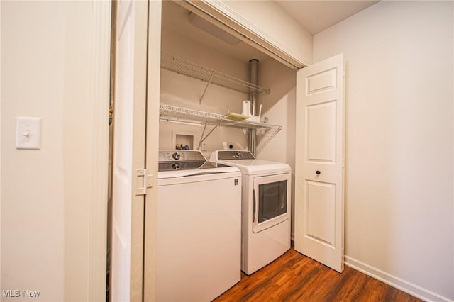laundry area with laundry area, dark wood finished floors, independent washer and dryer, and baseboards