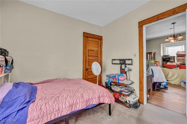 carpeted bedroom with an inviting chandelier