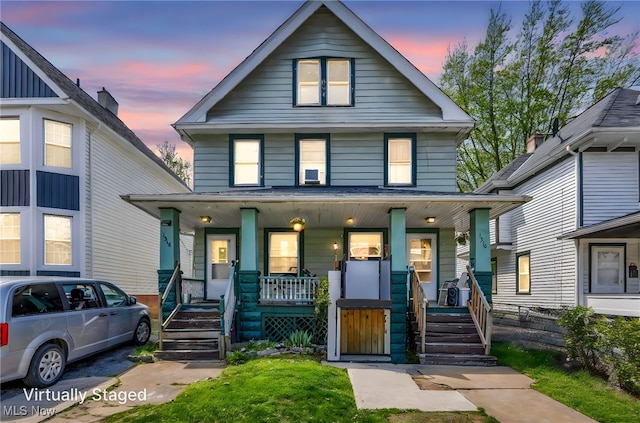 traditional style home featuring covered porch