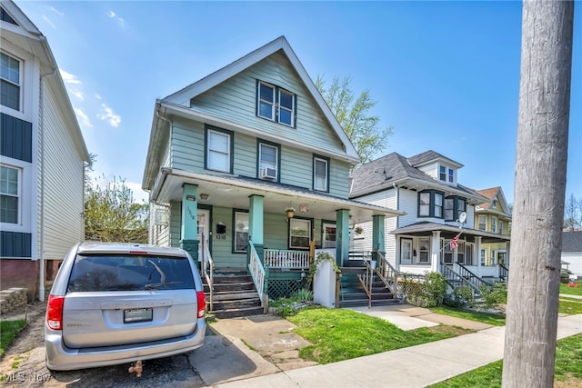 american foursquare style home with covered porch