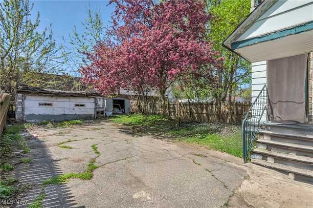 exterior space featuring fence and an outbuilding