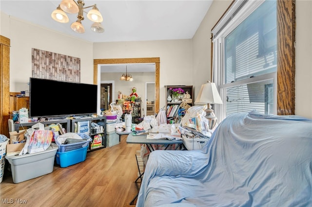living room featuring wood finished floors and a chandelier