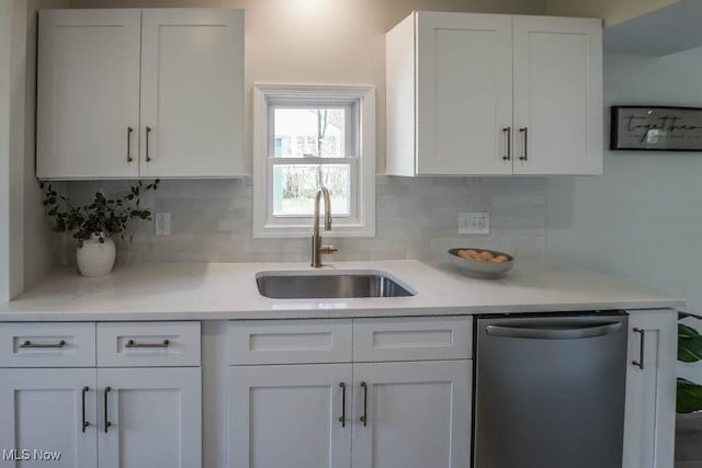kitchen featuring a sink, white cabinetry, dishwasher, and light countertops