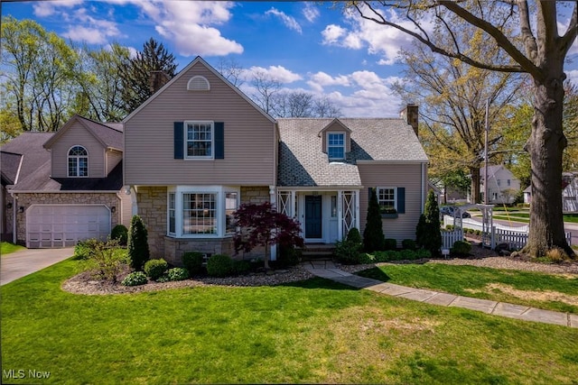 view of front facade featuring a front lawn, driveway, stone siding, and a chimney