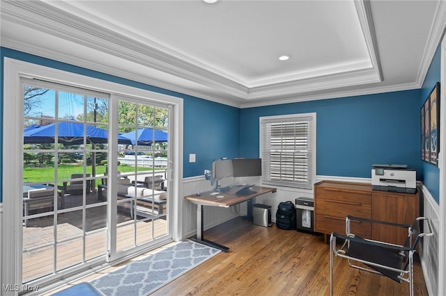 office featuring ornamental molding, wainscoting, wood finished floors, and a raised ceiling