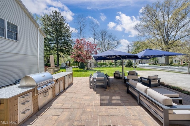 view of patio / terrace featuring an outdoor kitchen, a shed, an outdoor living space, an outdoor structure, and a grill
