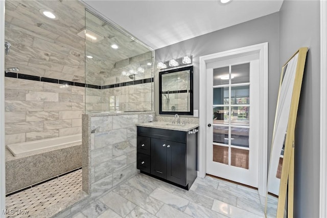 full bathroom with vanity, marble finish floor, and a walk in shower