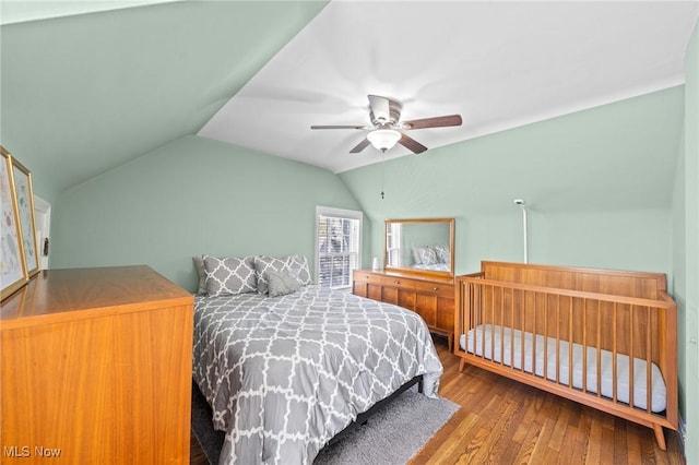 bedroom featuring ceiling fan, vaulted ceiling, and wood finished floors