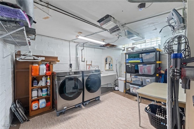 laundry room with laundry area, washer and clothes dryer, and a sink