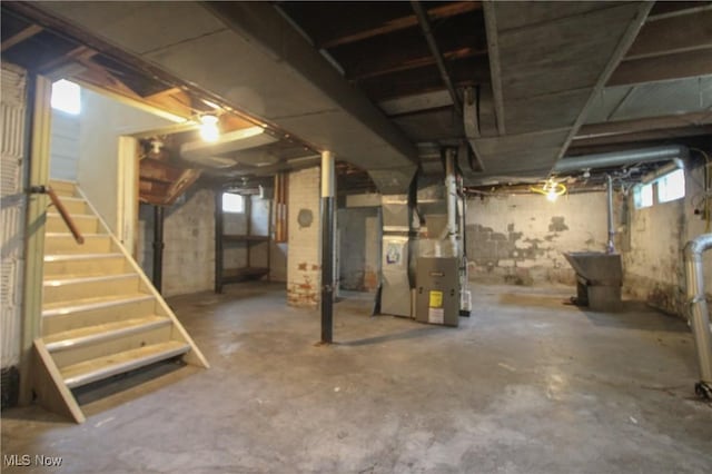 132 Jennette Dr, Boardman, OH 44512 - below grade area with stairway, heating unit, and plenty of natural light
