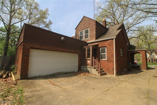 132 Jennette Dr, Boardman, OH 44512 - view of front of house featuring brick siding, driveway, a chimney, and a garage
