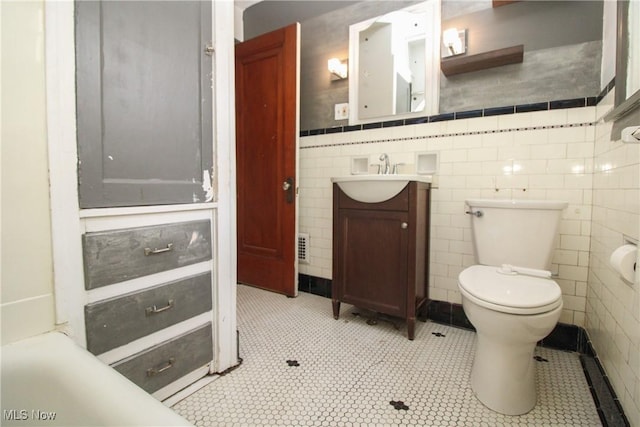 132 Jennette Dr, Boardman, OH 44512 - bathroom featuring tile patterned flooring, tile walls, toilet, and vanity