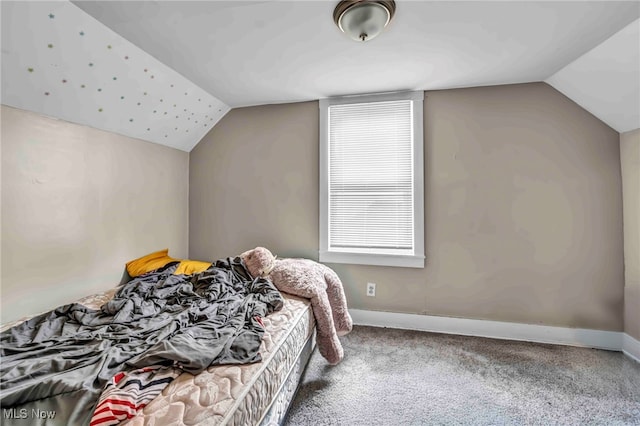 bedroom featuring carpet flooring, baseboards, and lofted ceiling