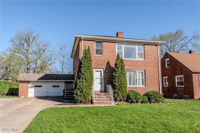 colonial-style house with brick siding, driveway, a chimney, and a front lawn