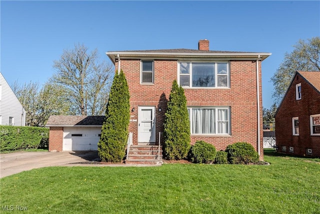 view of front facade featuring entry steps, a chimney, brick siding, and a front yard