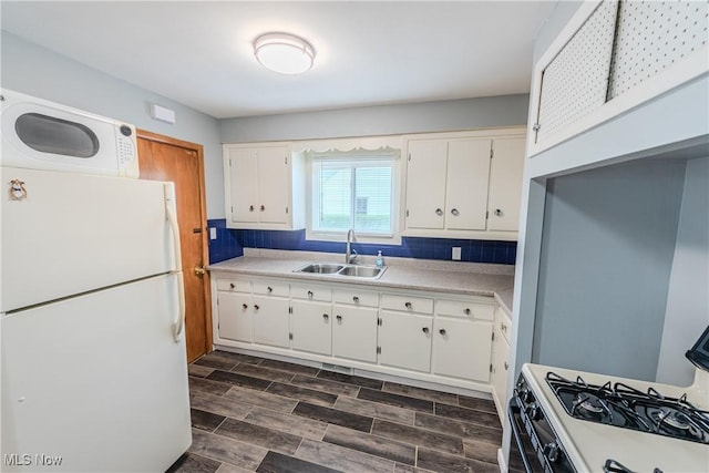 kitchen featuring a sink, white cabinetry, white appliances, and light countertops
