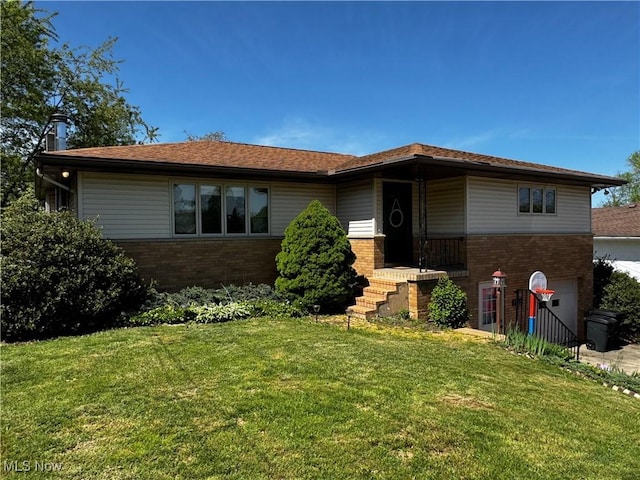 single story home with brick siding and a front yard