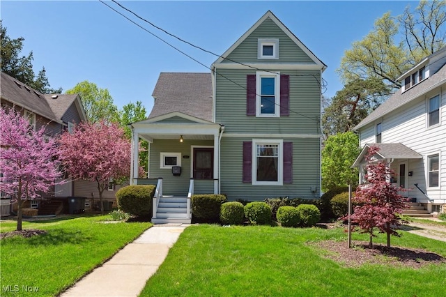 victorian home featuring covered porch and a front yard