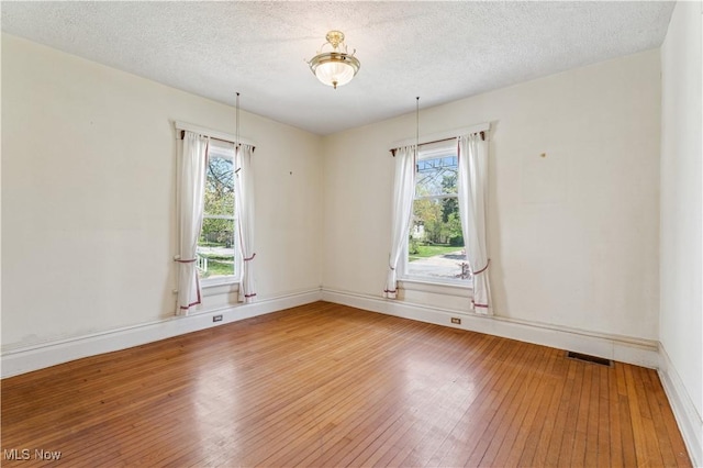 162 S Cedar St, Oberlin, OH 44074 - unfurnished room featuring light wood-style floors, baseboards, and a textured ceiling