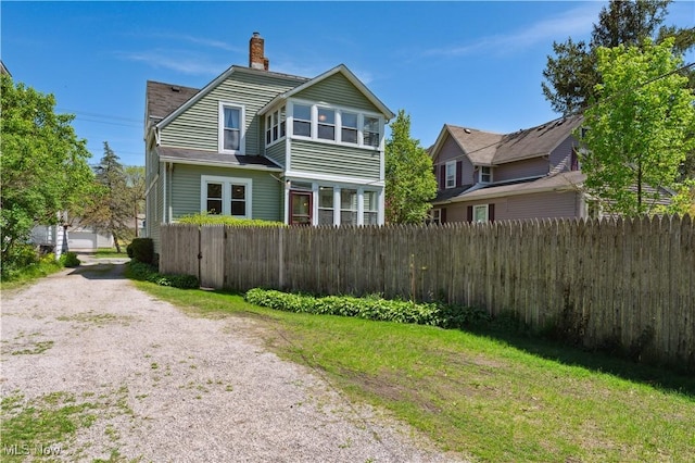 162 S Cedar St, Oberlin, OH 44074 - view of side of home featuring a chimney and driveway