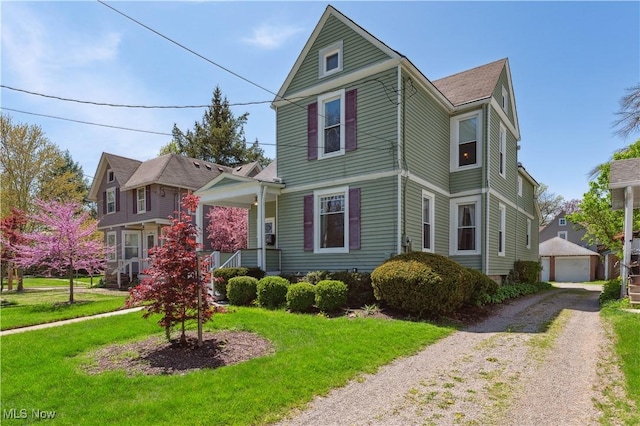 162 S Cedar St, Oberlin, OH 44074 - victorian home with an outdoor structure, a front yard, and a porch