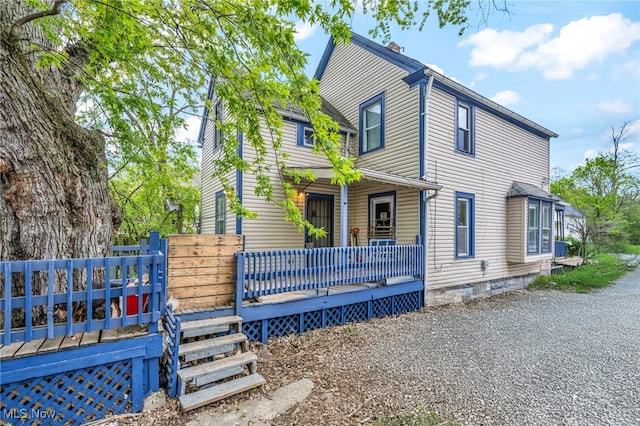 view of home's exterior featuring a porch and crawl space